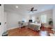 Inviting bedroom space with hardwood floors and a ceiling fan complementing the natural light at 305 Caledonia Way, Waxhaw, NC 28173