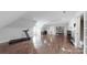 Expansive bonus room with hardwood floors, a treadmill, a kitchenette, and ample open space at 305 Caledonia Way, Waxhaw, NC 28173