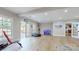 Spacious bonus room with bright neutral colors, multiple doors to the outside and wood floors at 305 Caledonia Way, Waxhaw, NC 28173