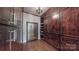 Spacious walk-in closet with custom wood cabinetry, a full-length mirror, and hardwood floors at 305 Caledonia Way, Waxhaw, NC 28173