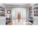 Inviting foyer with hardwood floors, built-in bookshelves, and ample natural light at 305 Caledonia Way, Waxhaw, NC 28173