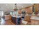 Spacious kitchen with wooden cabinetry, island with dark wood, and stainless steel appliances at 305 Caledonia Way, Waxhaw, NC 28173
