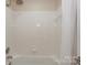 Well-lit bathroom featuring a shower and tub combination with white tile and neutral walls at 368 Northwest Dr, Davidson, NC 28036