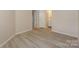 Clean bedroom featuring neutral walls, a large closet, and new wood-look floors for modern comfort at 368 Northwest Dr, Davidson, NC 28036