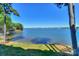 Beautiful view of the lake and shoreline, enhanced by lush green grass and mature trees at 368 Northwest Dr, Davidson, NC 28036