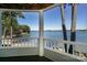 Picturesque lake view from a covered porch with white railings and a wooden ceiling at 368 Northwest Dr, Davidson, NC 28036