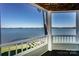 Breathtaking lake view from covered porch featuring white railings and a wooden ceiling at 368 Northwest Dr, Davidson, NC 28036