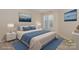 Staged main bedroom with a plush bed, side tables, lamps, decor, and an abundance of natural light at 368 Northwest Dr, Davidson, NC 28036