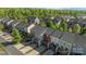 Aerial view of modern townhomes, each with a private deck and driveway in a green, community setting at 4056 Zilker Park Dr, Charlotte, NC 28217