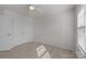 Simple bedroom features neutral carpeting, a ceiling fan, and ample closet space at 4056 Zilker Park Dr, Charlotte, NC 28217