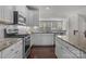 Well-equipped kitchen featuring stainless steel appliances, granite countertops, and ample cabinet space at 4056 Zilker Park Dr, Charlotte, NC 28217
