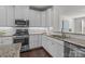 Modern kitchen featuring white cabinets, stainless steel appliances, and granite countertops at 4056 Zilker Park Dr, Charlotte, NC 28217