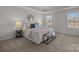 Bright main bedroom with a king bed, two windows, and comfortable carpeting at 4056 Zilker Park Dr, Charlotte, NC 28217