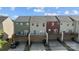 Rear view of contemporary townhomes, each featuring a private elevated deck and convenient driveway access at 4056 Zilker Park Dr, Charlotte, NC 28217