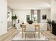 Modern dining room with a wood table, six chairs, and a large indoor tree at 4124 Skyboat Cir, Fort Mill, SC 29715