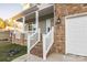 Welcoming front porch with brick stairs and white railings, leading to the main entrance and garage at 4176 River Run Cir, Hickory, NC 28602