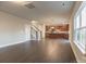 Open-concept living area with hardwood floors, a staircase, and natural light, adjacent to the kitchen at 4176 River Run Cir, Hickory, NC 28602