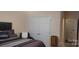 A cozy bedroom is staged with a closet, bed, and a vintage nightstand at 426 Summer Ridge Rd, Stanley, NC 28164