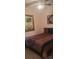 Calm bedroom with soft lighting, unique wall art and comfortable bed covered in a patterned brown spread at 426 Summer Ridge Rd, Stanley, NC 28164