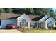 Charming single story home with brown roof, red shutters, lush lawn and a beautiful red vehicle in the driveway at 426 Summer Ridge Rd, Stanley, NC 28164