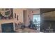 A warm living area with a dark fireplace, view into the dining room and neutral decor accents at 426 Summer Ridge Rd, Stanley, NC 28164