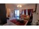 Cozy living room featuring a plush tan sofa, warm red curtains, and decorative glass table at 426 Summer Ridge Rd, Stanley, NC 28164