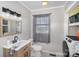 This bathroom offers a stylish vanity, neutral color palette, and next to the laundry area at 44392 Dennis Rd, Albemarle, NC 28001