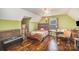 This is a comfortable bedroom with hardwood floors, a ceiling fan and colorful accents at 44392 Dennis Rd, Albemarle, NC 28001