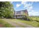 Charming home featuring a brick facade, inviting front porch, and lush greenery at 44392 Dennis Rd, Albemarle, NC 28001