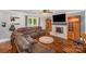 Spacious living room with a brick fireplace, ceiling fan, and a large sectional couch at 44392 Dennis Rd, Albemarle, NC 28001