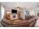 Cozy living room with a brick fireplace, hardwood floors, and comfortable seating arrangement at 44392 Dennis Rd, Albemarle, NC 28001