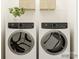 Modern laundry room with sleek, front-load washer and dryer units at 4551 Potters Wheel Dr, Fort Mill, SC 29715