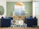 Inviting living room featuring blue chairs, a round coffee table, and stylish decor at 4551 Potters Wheel Dr, Fort Mill, SC 29715