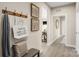 Welcoming hallway with decor and bench seating with coat hooks that enhances the entryway's charm at 517 Durango Way, Denver, NC 28037