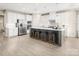 Bright, modern kitchen with stainless steel appliances, a large island with seating, and a tiled backsplash at 517 Durango Way, Denver, NC 28037