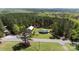 A home with a pool and barn surrounded by lush greenery as seen from above at 5381 Mount Carmel Rd, Heath Springs, SC 29058