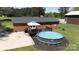 Backyard pool and deck area with a white umbrella, perfect for outdoor relaxation at 5381 Mount Carmel Rd, Heath Springs, SC 29058