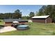 Aerial view of a backyard with an above ground pool, deck and well-manicured lawn at 5381 Mount Carmel Rd, Heath Springs, SC 29058