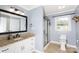 Bathroom with granite counters, white cabinets, and a framed glass shower at 5381 Mount Carmel Rd, Heath Springs, SC 29058
