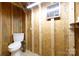 Small bathroom with a toilet, wall mirror, and a shelf for storage at 5381 Mount Carmel Rd, Heath Springs, SC 29058