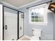 Bathroom featuring a walk-in shower with glass door and updated fixtures at 5381 Mount Carmel Rd, Heath Springs, SC 29058