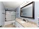 Bathroom showcasing vanity with granite countertops, a bathtub with shower, and a large mirror at 5381 Mount Carmel Rd, Heath Springs, SC 29058