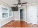 Bright bedroom featuring a ceiling fan, wood flooring, and an attached bathroom with modern fixtures at 5381 Mount Carmel Rd, Heath Springs, SC 29058