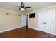 Bedroom with ceiling fan, mounted TV, and wood floors at 5381 Mount Carmel Rd, Heath Springs, SC 29058