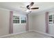 Bedroom featuring two large windows with curtain coverings and neutral carpeting at 5381 Mount Carmel Rd, Heath Springs, SC 29058