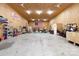 Large, unfinished garage space with high ceilings, multiple ceiling fans, and an American flag at 5381 Mount Carmel Rd, Heath Springs, SC 29058