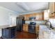 Modern kitchen with stainless steel appliances, wooden cabinets and an island for extra prep space at 5381 Mount Carmel Rd, Heath Springs, SC 29058