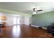 Spacious living room with hardwood floors, fan, and french doors at 5381 Mount Carmel Rd, Heath Springs, SC 29058