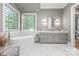 The primary bathroom features a soaking tub, marble floors, a vanity, and window with blinds at 542 Lochaven Rd, Waxhaw, NC 28173
