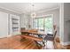 Bright dining room featuring a wooden table, bench, and chairs beneath a modern chandelier at 542 Lochaven Rd, Waxhaw, NC 28173